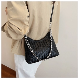 Detail of black woven leather shoulder bag with silver chain and crossbody strap