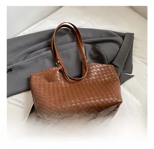 Macro detail of the brown leather Intrecciato weave texture on this woven tote bag