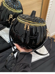 Glossy black pumpkin shoulder bag with devil face relief and gold zippers for Halloween