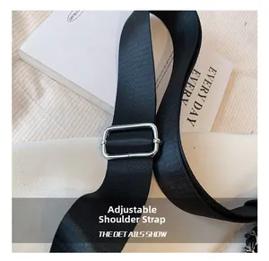 Adjustable black woven nylon shoulder strap with a silver metal buckle detail