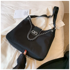 Detail of black large capacity hobo bag with silver chain and metal clasp