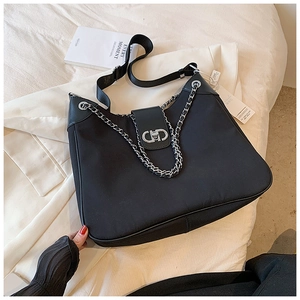 Close-up of black nylon tote bag with silver chain and CD metal buckle detail