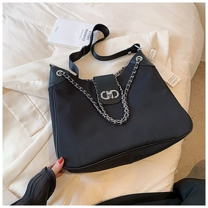 Detail of black waterproof nylon tote with silver chain and adjustable strap