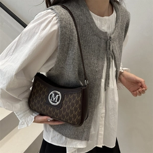 Chic dark brown underarm bag with vintage M-letter monogram and silver metal logo