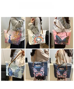 Detail view of canvas bucket bags with six artistic prints and brown leather straps