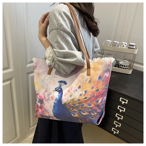 Artistic peacock print canvas shoulder bag with tassel detail and brown leather handle