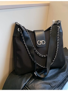 Black nylon shoulder bag with leather trim, silver CD clasp and versatile dual straps