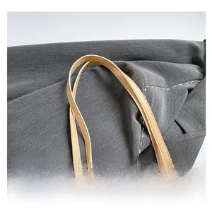 Detailed close-up of soft beige PU leather shoulder bag handles with precision stitching