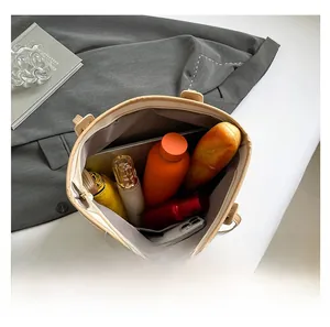 Top view of spacious beige tote bag showing internal storage for daily essentials