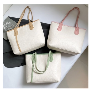 Top view of three large capacity tote bags with embossed heart and love patterns