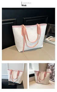 Detail of pink and white tote bag with embossed hearts and smiley patterns