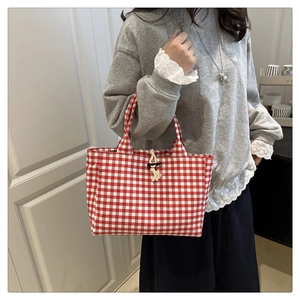 Détail du sac cabas à carreaux rouges et blancs avec fermeture à bouton en bois