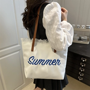 Minimalist canvas tote bag with Summer embroidery, tassel edge and leather straps