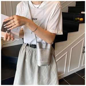 Detail of silver lychee texture leather mini bucket bag with slender shoulder strap