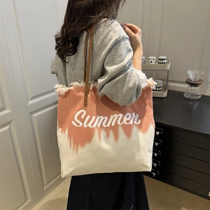 Canvas tote bag with pink gradient, Summer lettering and fringe trim on a model