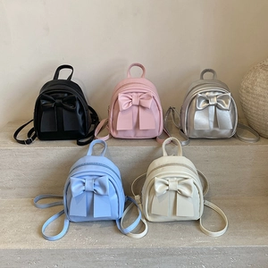 Mini PU leather bow backpacks in five colors displayed on steps for a stylish look