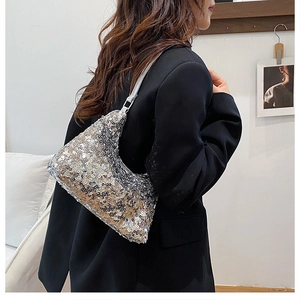 Detail of silver and black sequin hobo bag paired with a modern black blazer outfit