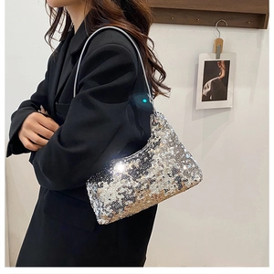 Close-up of a silver sequined shoulder bag reflecting light with elegant metallic texture