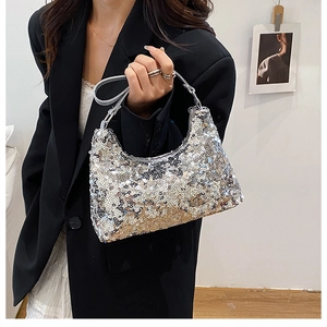 Close-up of sparkling silver and gold sequins on this trendy crescent hobo evening bag