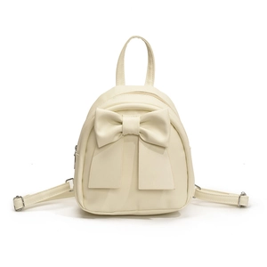 Trendy cream bow mini backpack for women featuring a minimalist aesthetic and smooth finish