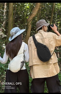 Outdoor crossbody chest bag detail showing beige and black nylon styles with side mesh pocket
