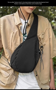 Detail of durable black nylon crossbody chest bag with side mesh pocket and utility straps
