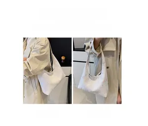 Detail showing the white shoulder bag with colorful vintage monogram print on leather