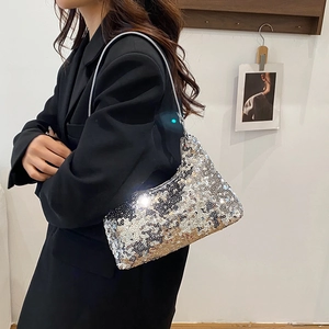 Chic silver sequin crescent hobo bag for women worn over shoulder with stylish black blazer