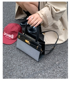 Detail view of contrast stitch shoulder bag with grey herringbone fabric and gold lock