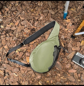 Detail of olive green waterproof nylon chest bag with breathable mesh pocket and drawstrings