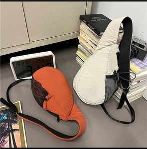 Detail of orange and white nylon crossbody bags with side mesh pockets and mesh strap