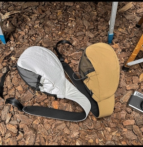 Outdoor lifestyle shot of lightweight nylon crossbody bags in white and khaki colors