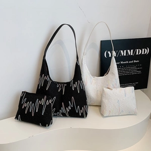 Chic black and white underarm tote bags set with textured embroidery and pouch