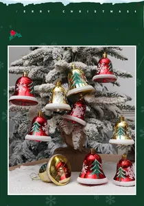 Macro view of red and gold Christmas bell ornaments with glitter tree and snowflake patterns