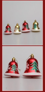 Detail of red and gold Christmas bell ornaments with tree prints and snowy glitter finish