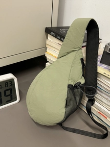 Waterproof nylon crossbody chest bag in olive green with adjustable strap and mesh pocket