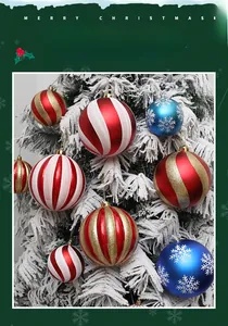 Detail of diverse 10cm-15cm pumpkin Christmas balls hanging on snow-covered tree