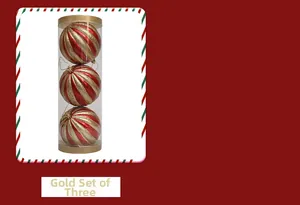 Three red and gold glitter stripe Christmas ball ornaments in a clear cylinder box