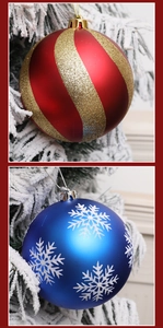 Close-up of matte Christmas ball ornaments with gold spiral and white snowflake patterns