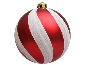 Detail of red matte Christmas ball with white glitter swirl patterns and golden cap