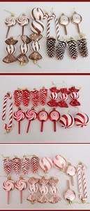 Three-tiered display of candy canes, lollipops, and pine cones in bronze, red, and rose gold