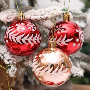 Bolas de Navidad pintadas a mano con copos de nieve en rama de pino con nieve