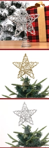 Detail of glittery gold and silver star tree toppers with spiral spring base support