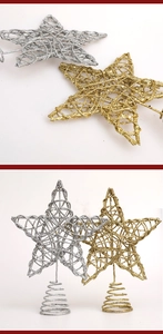 Detail of gold and silver glitter Christmas tree topper stars with spring base