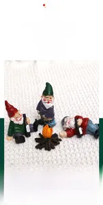 Three garden gnome figurines with a glowing simulated campfire and musical light features