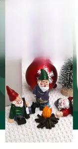 Detailed view of three resin Christmas gnomes with a miniature campfire festive ornament