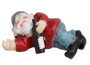 Detailed view of a funny drunken garden gnome figurine in a relaxed side-lying pose