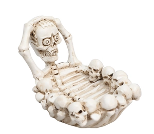 Detailed view of skull resin ashtray with antique finish and skeletal base design
