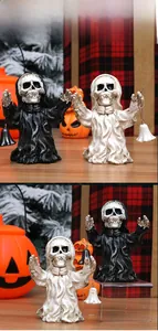 Detail of Halloween grim reaper resin figures with robes and small metal bells