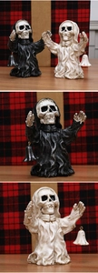 Detail of gothic skeleton figurines in black and white robes with metal bells